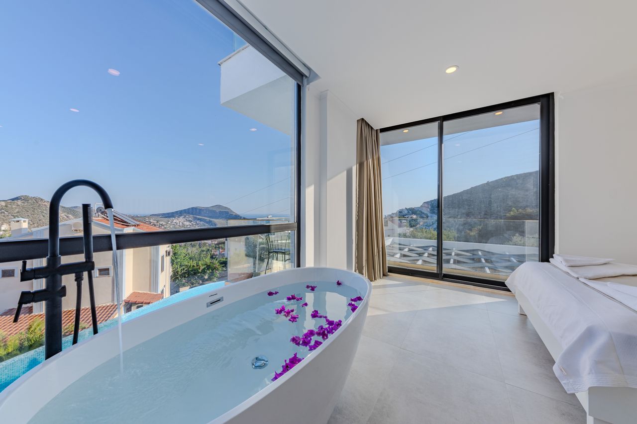 contact-img Elegant bathroom with a bath and mountain view, perfect for relaxation and luxury travel.